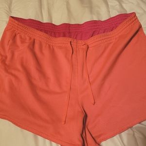 Reversible workout shorts. Corral/pink